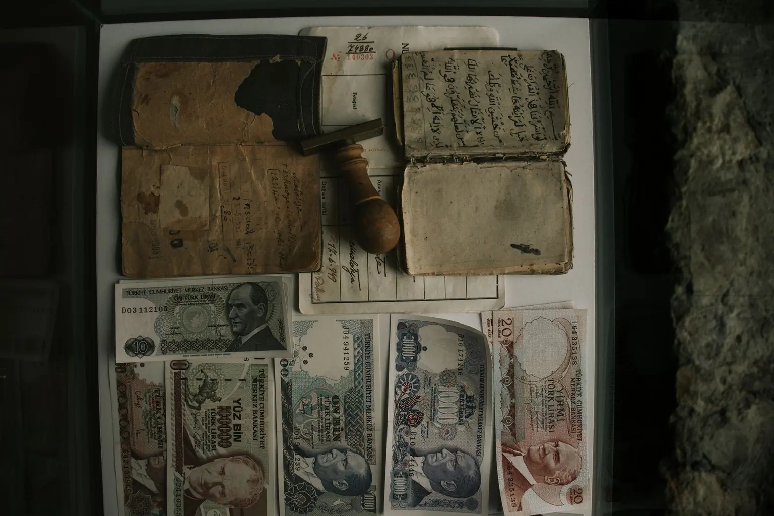 Vintage Turkish banknotes arranged with handwritten documents and an archival stamp
